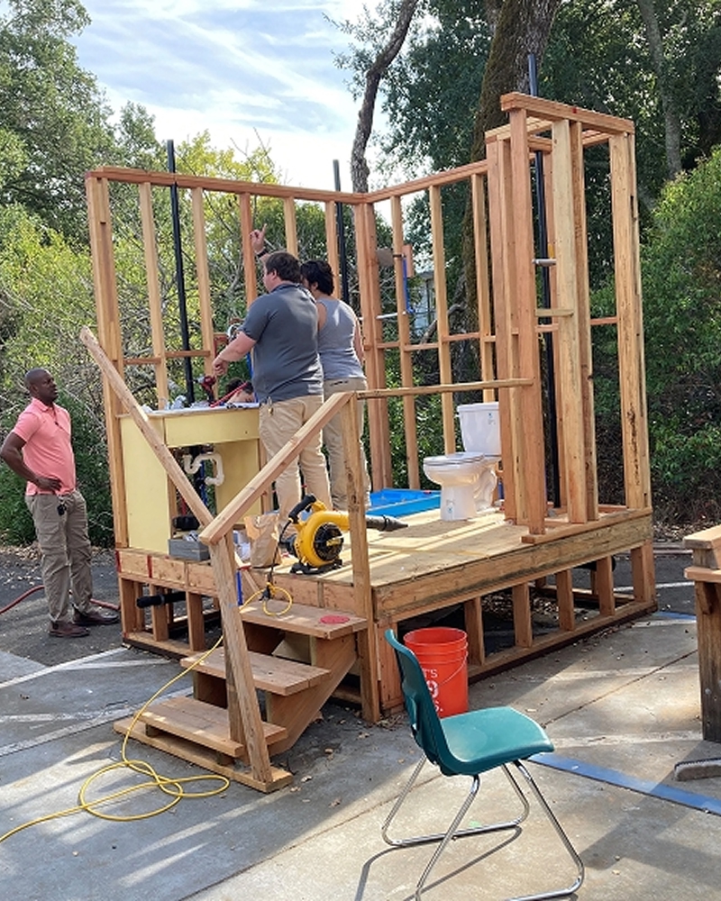 Students building a small wooden structure in CTE workshop.