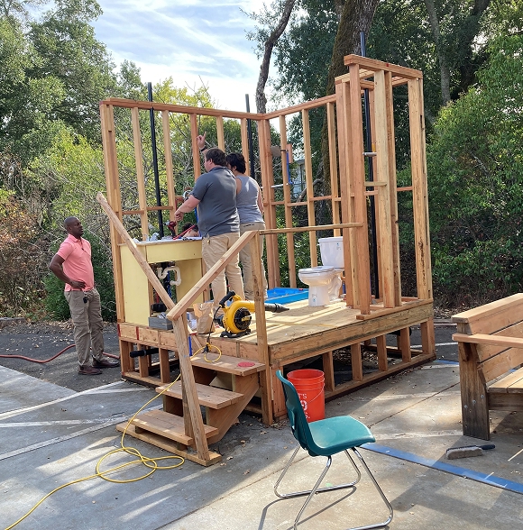 Students building a small wooden structure in CTE workshop.