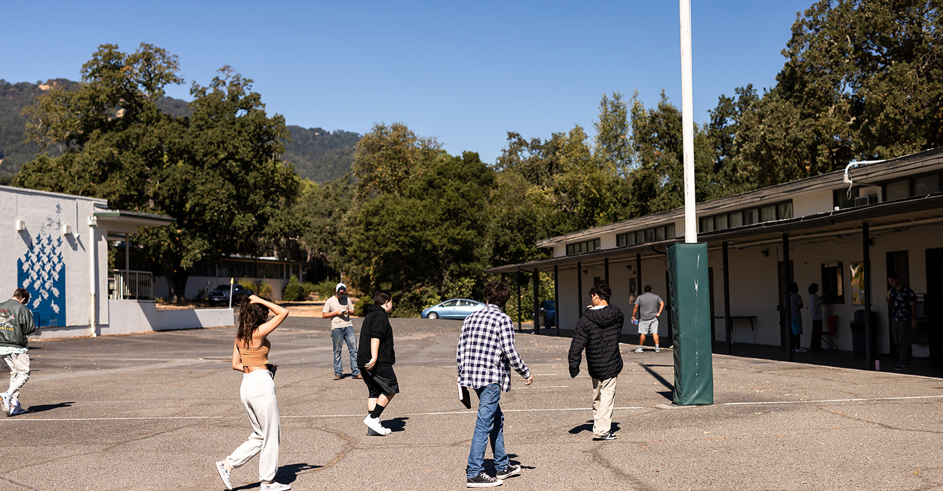 Students walking through the Hanna Academy campus courtyard.