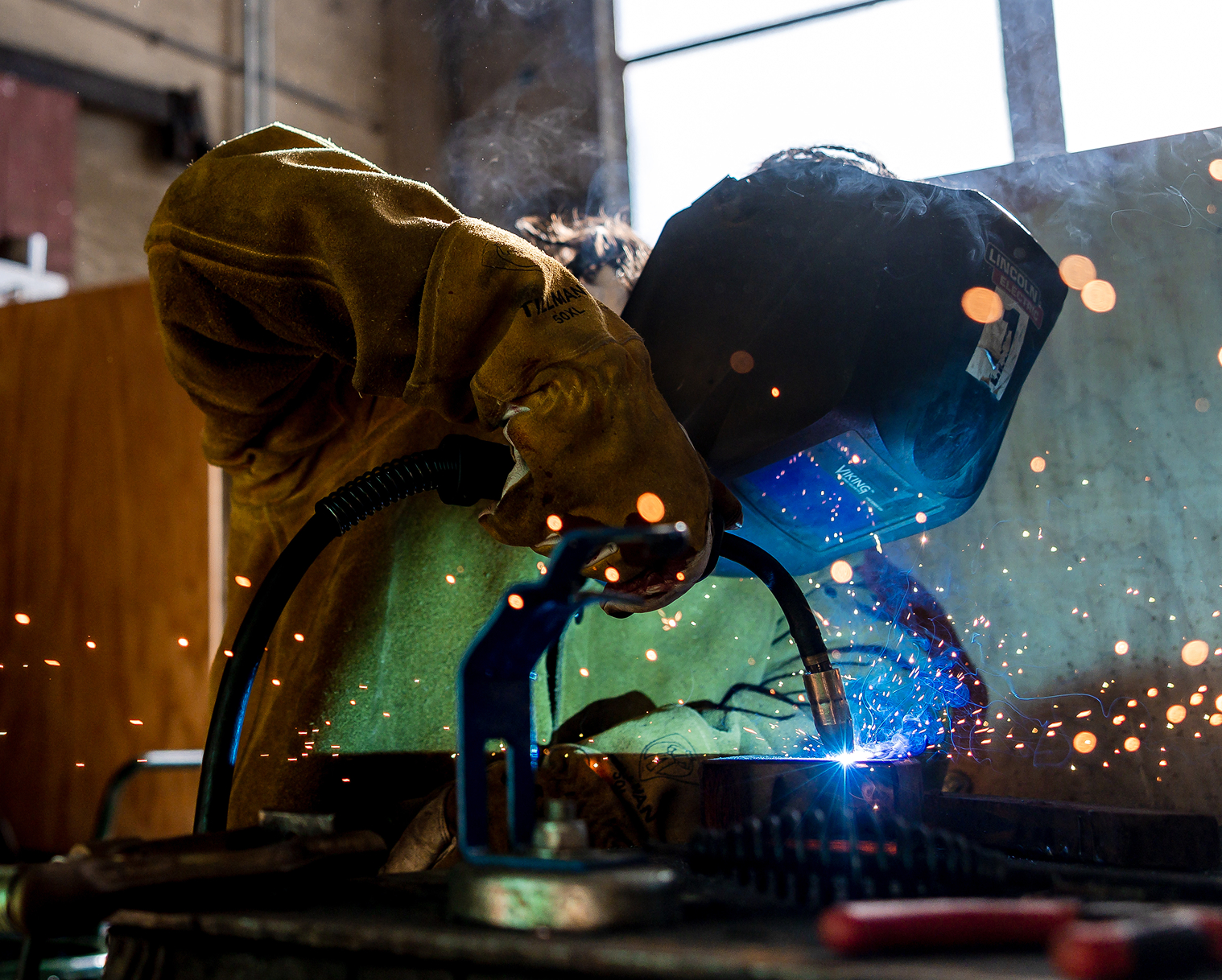 Student welding in Career Technical Education workshop.