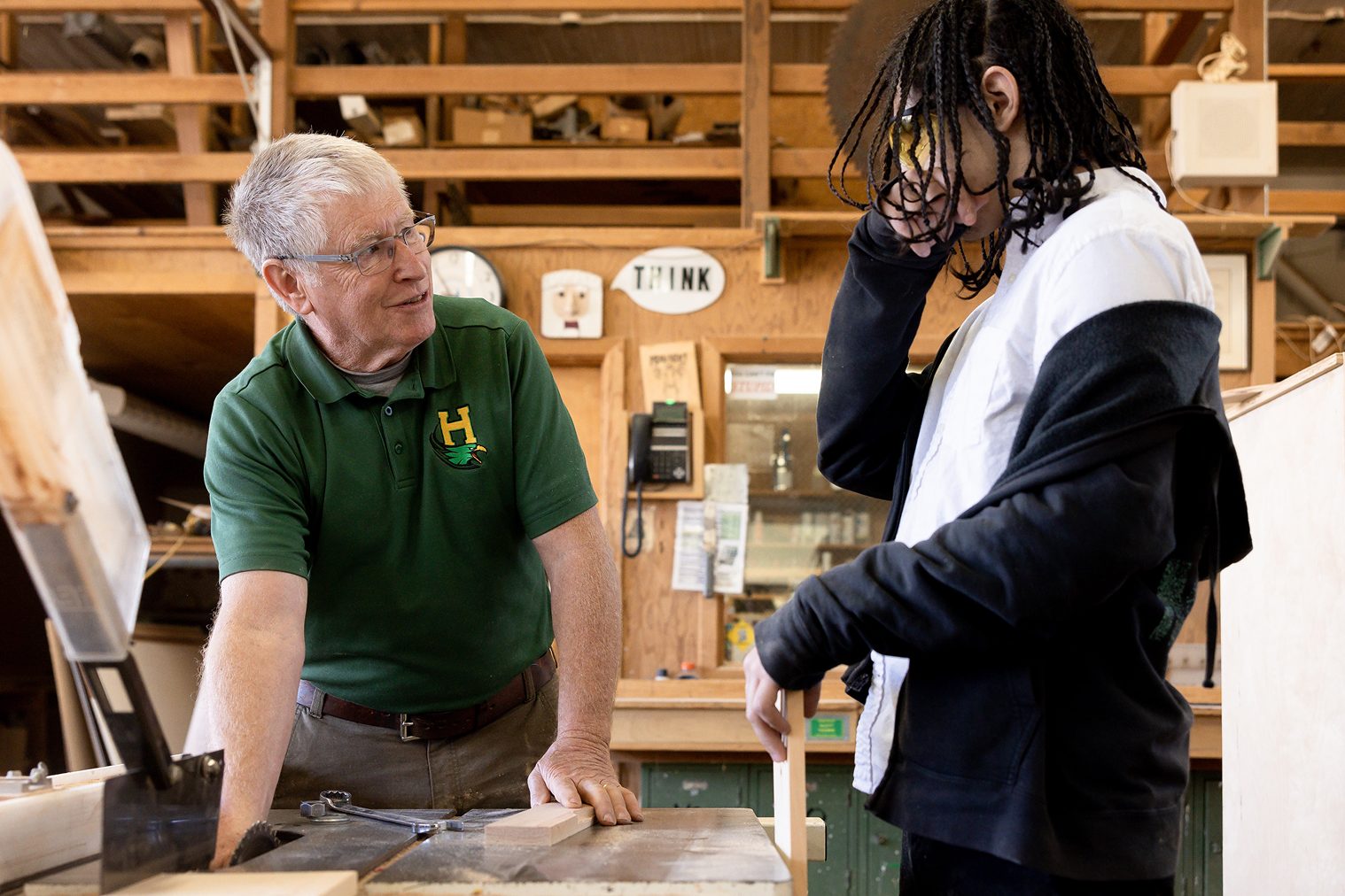 CTE workshop instructor guiding student work.