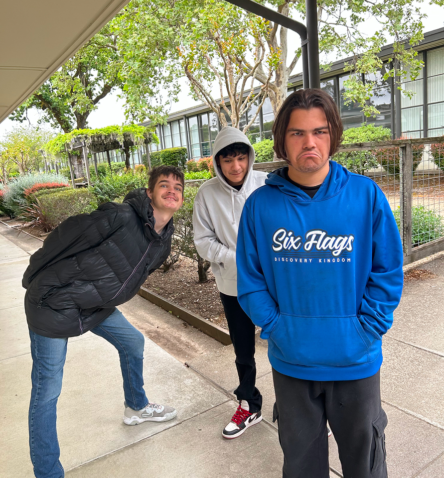 Group of students walking or standing together outside on campus.