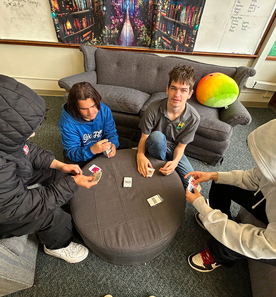 Students hanging out in lounge, playing games or relaxing.