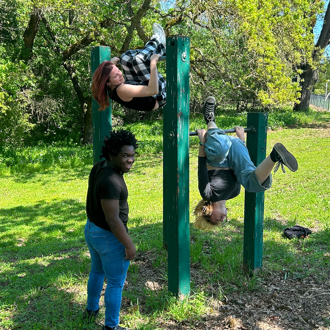 Students supporting each other during a climbing exercise.